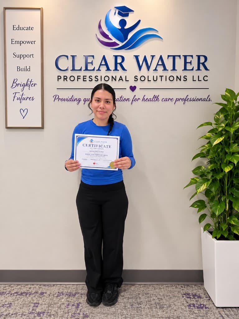 Clear Water graduate holding a Basic Life Support certificate in the Visalia studio